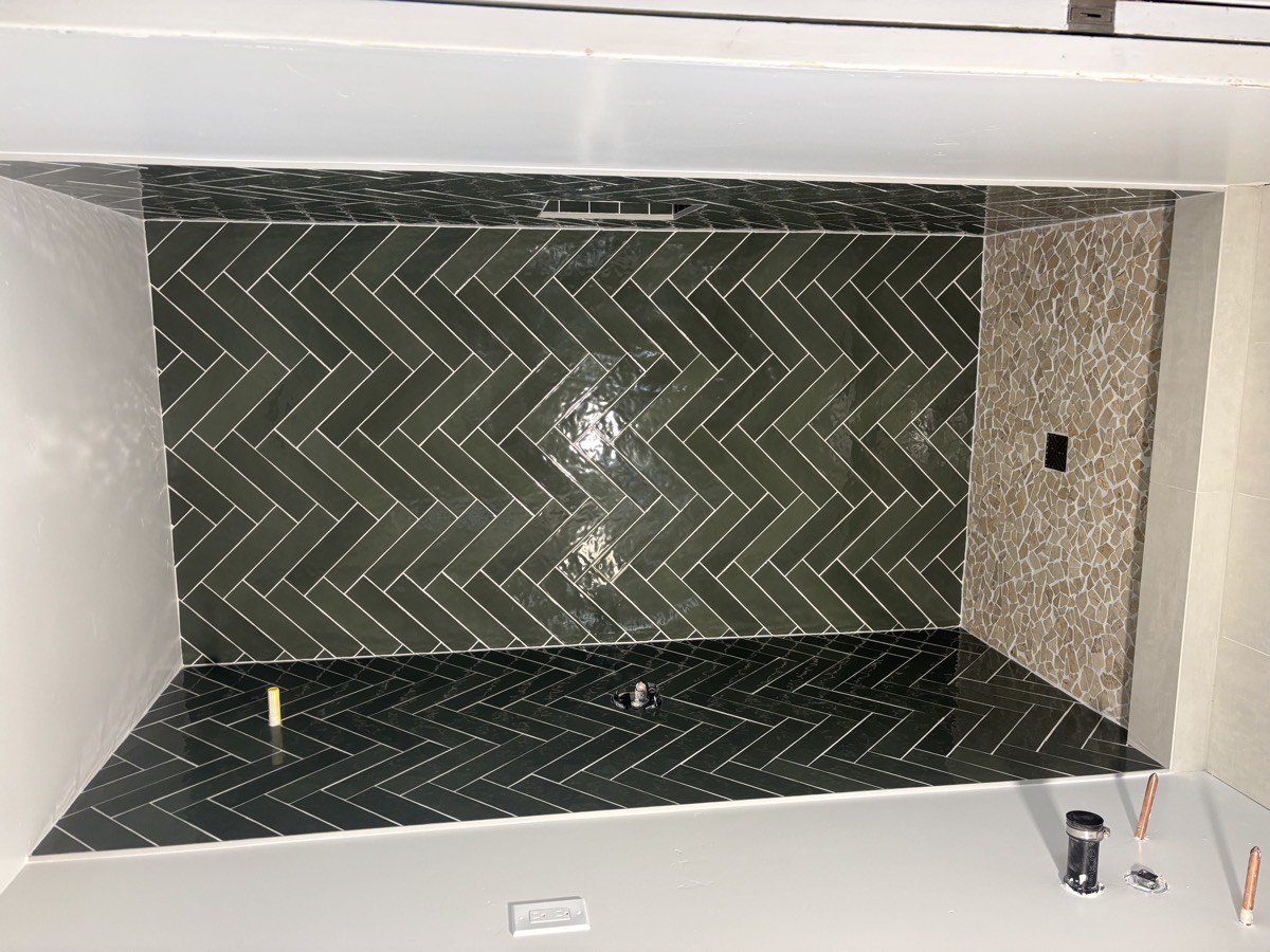 Herringbone pattern tile installation shower Sacramento
